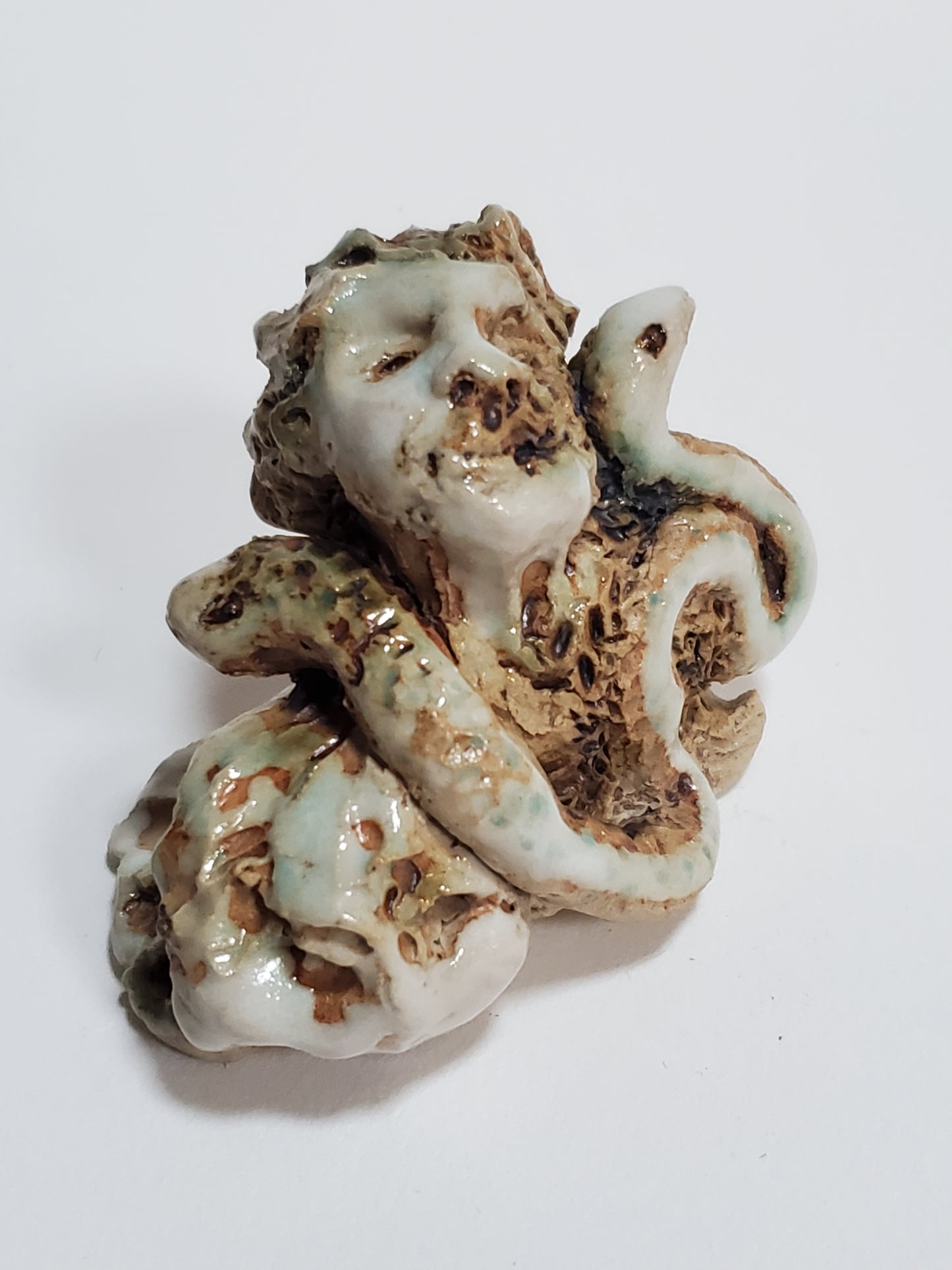 Set of 2 miniature ceramic sculptures, female figure with fish and shadow, figure with double-headed snake