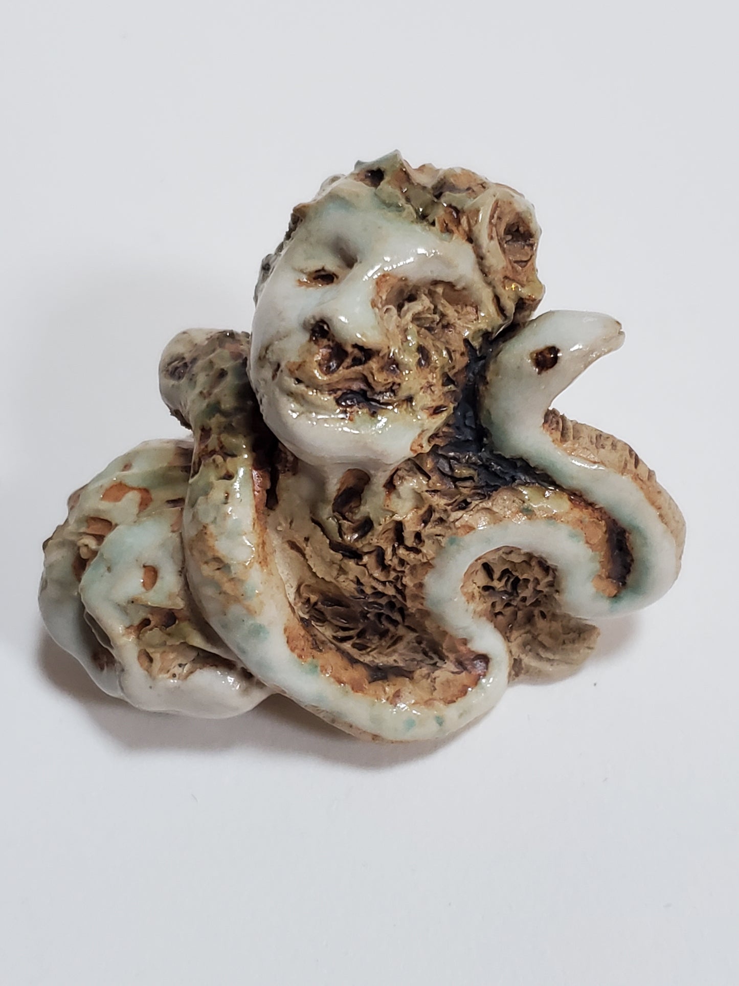 Set of 2 miniature ceramic sculptures, female figure with fish and shadow, figure with double-headed snake