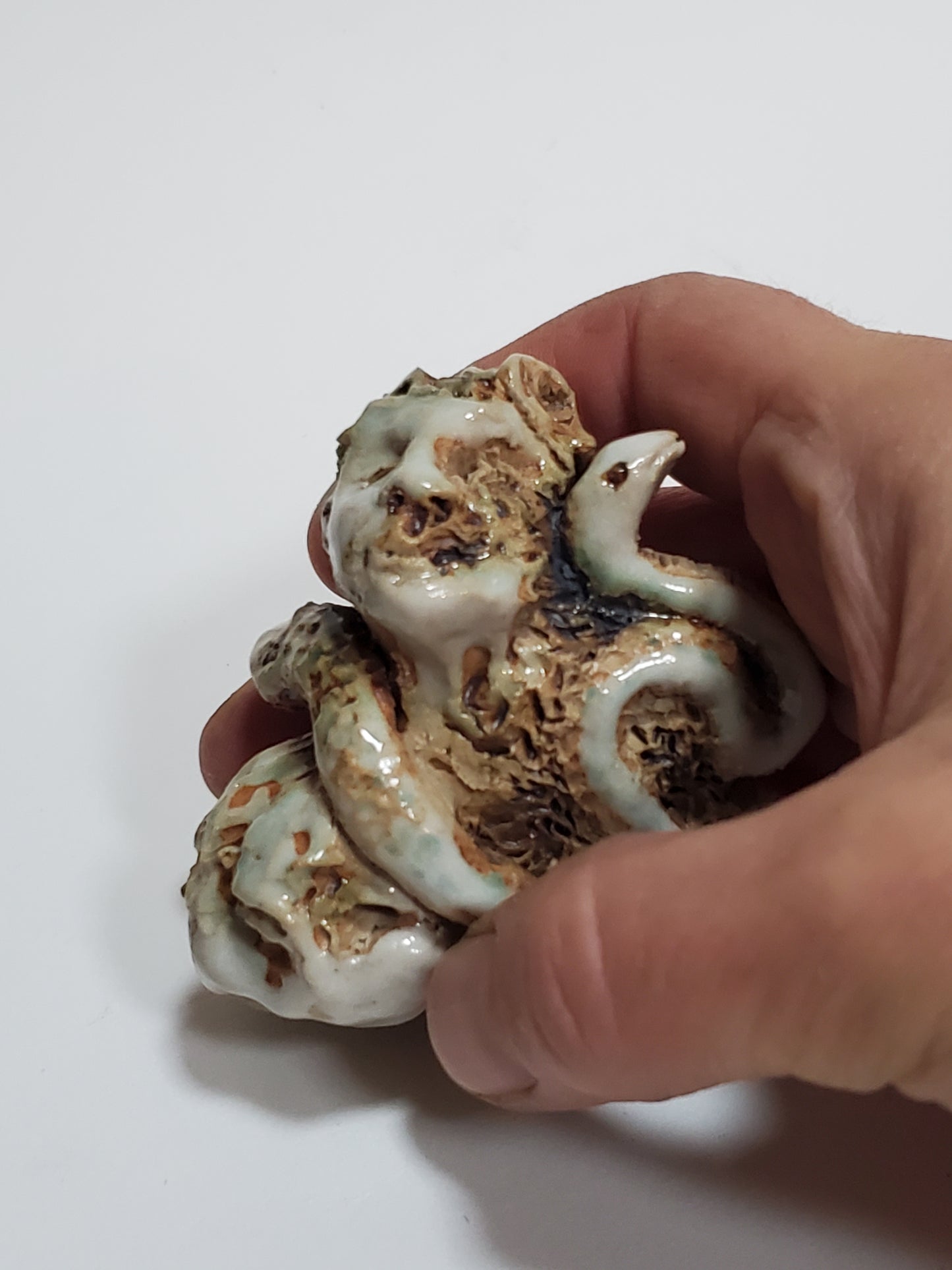 Set of 2 miniature ceramic sculptures, female figure with fish and shadow, figure with double-headed snake