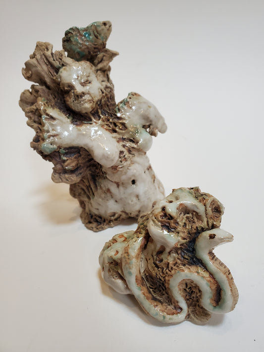 Set of 2 miniature ceramic sculptures, female figure with fish and shadow, figure with double-headed snake